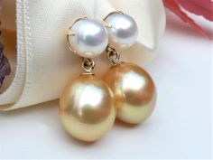 "Luxurious rich golden South Sea drop pearls dangling beneath six-prong set white freshwater pearl studs in solid 14k yellow gold. Timeless and classic pearl earrings. A fabulous addition to your jewelry collection. ✤ South Sea golden pearls are approx. 12.5 x 10.7mm, medium golden color. Very high luster, smooth surface with a few blemishes / very minor natural imperfection. ✤ South Sea pearl origin: Philippines. ✤ White freshwater pearls are 7mm, very high luster and smooth surface. ✤ Earrings Drop Pearl Earrings, Classic Pearl Earrings, Golden Pearl, Gold Pearl Earrings, Sea Pearl, White Freshwater Pearl, Sea Pearls, Golden Color, Pearl Studs