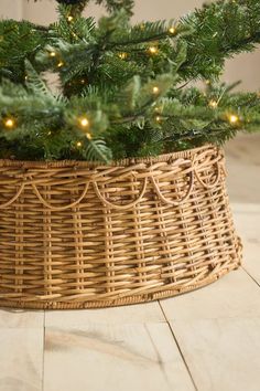 a christmas tree in a wicker basket with lights