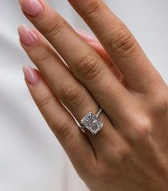 a woman's hand with a diamond ring on it