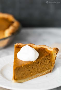 a slice of pumpkin pie with whipped cream on top