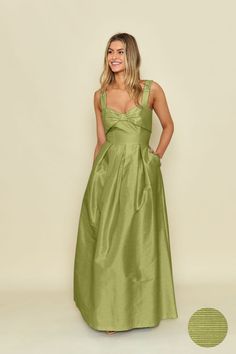 a woman in a green dress posing for the camera