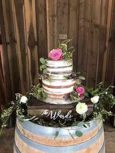 a wedding cake sitting on top of a barrel