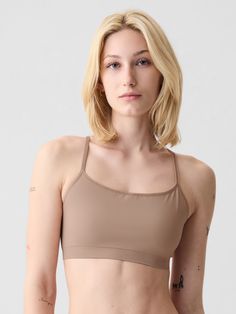 Supersoft, seamless, stretch nylon-blend bralette.  Scoop neck, racerback.  Elasticized trim at scoopneck, spaghetti straps.  This product was made in a factory that invests in gender equality and women’s empowerment.  Through RISE Reimagining Industry to Support Equality) and Gap Inc. ’s program P. A. C. E.  Personal Advancement & Career Enhancement), we support people who make our clothes to build the skills, knowledge, confidence, and resilience needed to advance in work and life.  Learn more Scoop Neck Bra With Built-in Support, Seamless Sports Bra With Scoop Neck And Minimal Stretch, High Stretch Scoop Neck Sports Bra With Built-in Bra, Scoop Neck Seamless Bra, Fitted Seamless Sports Bra With Scoop Neck, Seamless Fitted Sports Bra With Scoop Neck, Seamless Scoop Neck Sports Bra With Minimal Stretch, Seamless Sports Bra With Medium Support And Tank Straps, Medium Support Cami Sports Bra With Built-in Bra