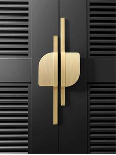 a black and gold door with two handles on each side, in front of some metal lockers