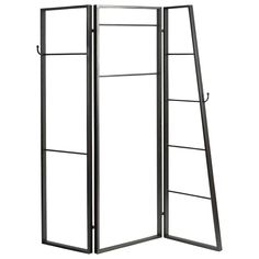 a tall metal folding screen on a white background