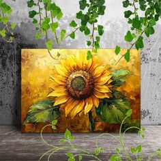 a painting of a yellow sunflower on a wooden table next to green leaves and branches