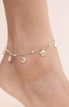 Online only! Add a touch of coastal elegance to your look with Ettika's Scallop Shell Anklet, featuring a delicate gold chain embellished with rhinestone details and charming seashell accents. The gold finish completes this stunning piece, perfect for enhancing your summer style.


	18k Gold Plated, Zinc, Glass Crystals
	8" with 1" extender
	Lobster Clasp Delicate Gold Bracelets For Summer, Delicate Gold Beach Jewelry, Adjustable Gold Strand Anklets, Elegant Gold Shell Bracelets, Elegant Gold Strand Jewelry, Elegant Gold-tone Beach Jewelry, Elegant Gold-tone Jewelry For Beach, Gold Adjustable Chain Anklet For Beach, Gold Delicate Anklets For Summer