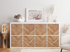 a white and wooden dresser with flowers on top