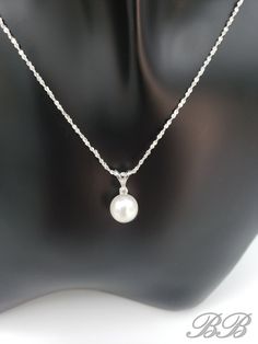 A timeless classic! This listing is for a 925 unplated sterling silver natural white freshwater cultured pearl necklace with a moissanite accent stone. Made to order. Please allow 3 weeks for the production of your necklace. Included in this purchase is a 1mm sterling silver chain in the style and length of your choosing. This necklace can be customized with any pearl color & size, or accent gemstone combination. Just message me for a quote =) Stone Dimensions 8MM Pearl, 2mm Round Moissanite *Li Classic Pearl Necklace With Pearl Pendant For Anniversary, Classic Pearl Pendant Necklace For Anniversary, White Birthstone Necklace For Formal Occasions, Formal White Birthstone Necklace, Classic Sterling Silver Pearl Drop Jewelry, Classic Pearl Necklace With Pearl Pendant, Classic Silver Solitaire Necklace With Birthstone, Classic Pearl Pendant Jewelry, White Gemstone Solitaire Necklace