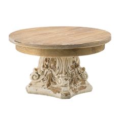 a round wooden table with carvings on the base and wood top, against a white background