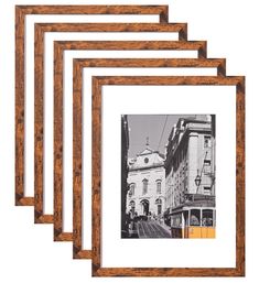 four wooden frames with black and white photos on them, each holding a city street scene