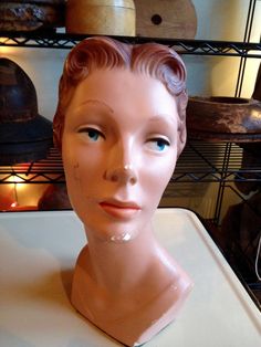 "This c.1940s mannequin display head is so lovely! She is quite elegant and composed. She is made of chalk. She has auburn molded hair and beautiful blue eyes. I have used her for years as a display for my hats, in various shops and studios. Her headsize is 20.5\", so she displays hats beautifully.  Like most of us, she has seen some wear - she's 85 years old! She has surface chips and scuffs, but no cracks or breaks. I covered her base with lamp felt, as she always left chalk dust on the shelves.  She measures approx. 14\"H x 8\"W $295.00 + shipping within USA only." Darth Vader Helmet, Head Display, Mannequin Display, Vintage Mannequin, Hat Display, Hat Organization, Vintage Millinery, Beautiful Blue Eyes, Mannequin Head