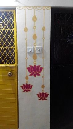 the door is painted yellow and white with red flowers on it