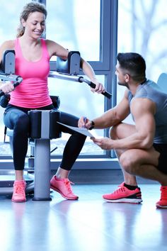 a man and woman working out on exercise machines