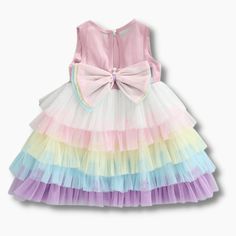 This charming, rainbow layered dress will make your little princess look just as glamorous as you! It features a multicolor, layered skirt, a tulle bodice and a bow at the back. Made for special occasions, this versatile dress can also be worn casually. Influencer @helena.modenezi Material: Cotton, polyester Tiered Tulle Skirt Dresses For Dress-up, Sleeveless Tulle Tutu Dress With Bow, Princess Style Tiered Summer Dress, Tiered Party Dress With Bow, Playful Ruffled Tutu Dress In Tulle, Playful Ruffled Tutu Dress, Playful Ruffled Tulle Tutu Dress, Tulle Tutu Dress With Bow For Dress-up, Summer Princess Dress With Ruffles And Tiered Shape