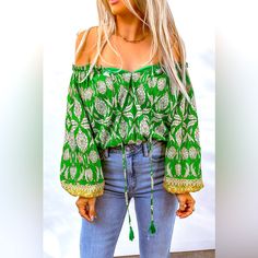 Bohemian Printed Tassel Tie Blouse! Designed With A Free-Spirited, Fun Touch, This Blouse Is Sure To Make An Impression Anywhere. It Features An Absolutely Dazzling Off-Shoulder Neckline, With A Drawstring Closure For That Perfect Fit. Long Balloon Sleeves Create An Elegant Silhouette, And The Floral Pattern Is Oh-So Chic. Add A Touch Of Boho Flair To Your Everyday Wardrobe With This Beautiful Boho Blouse You Won't Regret It! Pet Free/Smoke Free Home. Bohemian Spring Tops With Tassel Ties, Bohemian Tops With Tassel Ties For Spring, Bohemian Cotton Blouse With Back Tassel Tie-up, Long Sleeve Fringe Tops For Summer, Long Sleeve Fringe Tops For Festivals, Bohemian Long Sleeve Blouse With Back Tassel Tie-up, Green Bohemian Tops For Fall, Bohemian Fall Top With Tassels, Bohemian Fall Tops With Tassel Ties