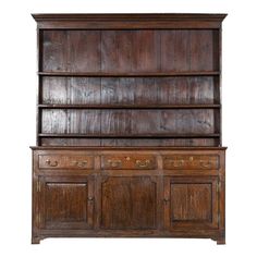 an old wooden bookcase with drawers and cupboards on the front, isolated against a white background