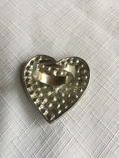 "Pave clear rhinestone heart shaped ring, very 70s. The heart is about 1.625 wide and tall. Classic cocktail ring, retro elegant. Size 8.5, but it's adjustable so it would fit to about size 10.5 comfortably. Could also be used as a scarf ring. Please know that if you don't like the way the ring fits, you can return it; you pay for the shipping, but there's no restocking fee or questions asked, I just refund the ring's cost. Also, please take a look at my storefront at: https://www.etsy.com/shop/ Silver Heart Shaped Metal Ring, Silver Heart-shaped Metal Ring, Metal Heart Ring As Gift, Vintage Metal Crystal Promise Ring, Vintage Open Heart Ring For Promise, Heart-shaped Metal Ring Gift, Vintage Open Heart Promise Ring, Metal Heart Ring For Valentine's Day, Metal Rings For Anniversary On Valentine's Day