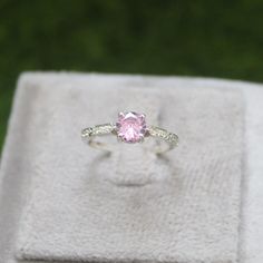 * Material: 925 Sterling Silver * DETAILS ✥ Handmade Ring ✥ - Center Stone: Lab Pink Sapphire  - Center Stone Size: 6 MM - Center Stone Shape: Round  - Side Stone: CZ diamond  ✥ O T H E R ∙ I N F O R M A T I ON ✥ ♦ Your item will be nicely packed to gift in elegant jewelry boxes. ♦ Custom Order We can make custom rings in almost any shape and style. If you want a specific model, please send us a clear picture and we will do our best. ♦ Delivery All Item will be Shipped within 3 to 5 Days after p Pink Diamond Rings With Diamond Cut, Pink Sterling Silver Crystal Ring With Center Stone, Pink Sterling Silver Crystal Ring With Gem, Pink Fine Jewelry Promise Ring, Pink Cubic Zirconia Classic Ruby Ring, Pink Diamond Promise Ring In Fine Jewelry Style, Pink Sterling Silver Diamond Ring With Accent Stones, Elegant Pink Sterling Silver Diamond Ring, Silver Pink Sapphire Ring As Gift