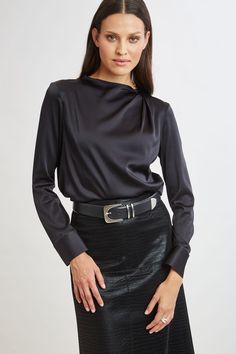 Chic & edgy, the draped neck of our luxe Silk Satin shirt creates a cool modern vibe that feels as good as it looks. The luxe patina, relaxed fit & soft neckline lend a feminine vibe to this must-have silk shirt. Elie Tahari Exclusive Long Sleeve Draped Neck Silk Shirt 93% Silk, 7% Elastane Runs true to Size Length From Shoulder to Hem: Back 23.25"L, Sleeve: 32.5"L (approx. length for size S) Model is 5'9" and wearing size XS Dry Clean Only Imported Style #: E9053534 Modern Blouse For Fall Night Out, Modern Blouse For Night Out In Fall, Modern Fall Blouse For Night Out, Modern Tops For Night Out In Fall, Sleek Long Sleeve Top For Evening, Elegant Draped Tops, Modern Black Blouse For Night Out, Draped Tops For Workwear In Fall, Draped Fall Tops For Workwear