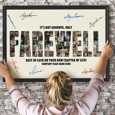 a woman holding up a framed poster with the words farewell