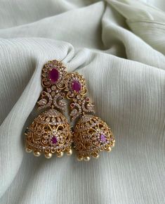 TEMPLE JHUMKA Kemp Ruby Stones Jhumka Earrings/Light weight /Antique Gold Finish/Indian Jewelry/desi jewelry / indian jhumkas Size : 3 inches approx  light weight  Elevate your style with these exquisite Temple Jhumka Earrings adorned with vibrant Kemp Ruby Stones and finished in antique gold. These Indian-inspired jhumkas are designed for both elegance and comfort, measuring approximately 3 inches in length and crafted to be delightfully lightweight. Embrace the timeless charm of desi jewelry with these stunning Indian jhumkas. Luxury Elegant Jhumkas For Reception, Luxury Intricate Design Jhumkas, Luxury Kundan Jhumkas In Temple Jewelry Style, Luxury Earrings For Eid Celebrations, Luxury Bollywood Jhumkas With Stone Work, Luxury Hand Set Fusion Bridal Earrings, Luxury Traditional Jhumkas With Intricate Design, Luxury Traditional Jhumkas For Wedding, Luxury Kundan Temple Jhumkas