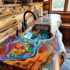 a sink made out of wood with colorful designs on the counter top and side panels