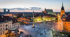 the city is lit up at night with people walking around and onlookers