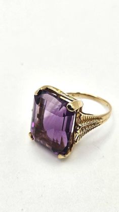 Vintage mid-century 10k gold amethyst ring. The amethyst is huge, measuring 18.3x14.5x9mm, approximately 11 carats. It appears nearly flawless and with beautiful color saturation. The setting is simple and elegant with detailing along the sides of the shank. There are no legible marks but it was tested as 10k gold. Size 6. Expedited shipping is available by request on a case by case basis. Please message us if you require rush shipping. Returns are are accepted within the time window noted. To r Dark Purple Engagement Ring, Classic 14k Gold Purple Amethyst Ring, Art Deco Purple Amethyst Ring For Formal Occasions, Purple Amethyst Art Deco Ring For Formal Occasions, Formal Art Deco Purple Amethyst Ring, Purple Amethyst Art Deco Ring, Classic Purple Amethyst Ring, Formal Vintage Amethyst Ring, Vintage 14k Gold Purple Jewelry