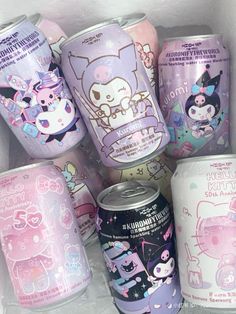 many different kinds of cans are in a white box with pink and purple designs on them