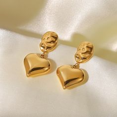 Embrace the essence of romance with Heart Drop Earrings, beautifully crafted in 18k gold plating. These earrings feature an elegant heart design that delicately drops, adding a touch of love and sophistication to any ensemble. Delivery Packaging, Feminine Jewelry, Gold Heart Earring, Green Skin, Heart Drop Earrings, Gold Drop Earrings, Stainless Steel Earrings, Heart Of Gold, Heart Design