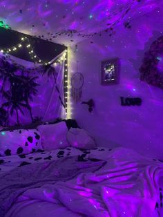 a bedroom with purple lights and decorations on the walls