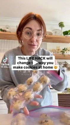 a woman in glasses is holding some cookies