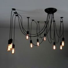 a chandelier with many light bulbs hanging from it's sides and wires attached to the ceiling