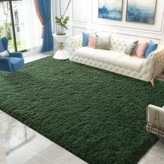 a living room filled with furniture and green carpet