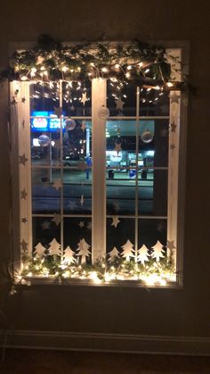 a window decorated with christmas lights and stars