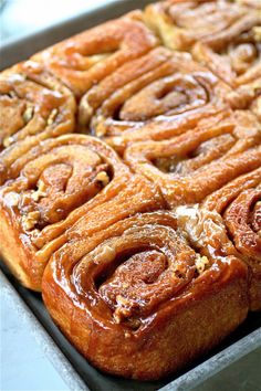 some cinnamon rolls sitting on top of a pan