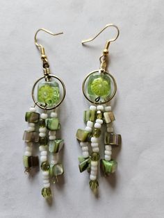 Glass flower bead with green and white dangles Green Earrings With Flower Charm For Jewelry Making, Bohemian Green Flower Charm Earrings, White Dangle Flower Earrings With Beads, Green Glass Dangle Jewelry, Adjustable Green Chandelier Earrings With Dangling Beads, Green Dangle Glass Earrings, Green Adjustable Dangle Flower Earrings, Green Glass Dangle Earrings, Green Czech Glass Dangle Earrings