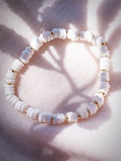 Choose one or all. These stretchy natural white puka shell bracelets evoke visions of Hawaii's white sands and soothing shores. Super rare tiny puka shells make these bracelets one of a kind.Stack these gold seashell bracelets high and you'll be ready for your tropical escape.✦ CHOICES DETAILED BELOW ✦✧ Style A: Natural White Baroque Freshwater Pearl✧ Style B: Natural Mauve Pink Freshwater Pearl✧ Style C: Natural 8-10mm Baroque Tahitian Pearl✧ Style D: Gold Filled Beads ✧ Style E: Gold Plated Sh White Beachy Bracelets For Everyday, Beachy White Bracelets With Round Beads, Elegant Adjustable Beaded Bracelets For Vacation, Elegant Adjustable Beaded Bracelet For Vacation, Beachy White Round Bead Bracelets, Beachy White Beaded Bracelet, White Everyday Beachy Bracelets, White Shell Bracelets As A Gift, White Shell Bracelets Perfect For Gifts