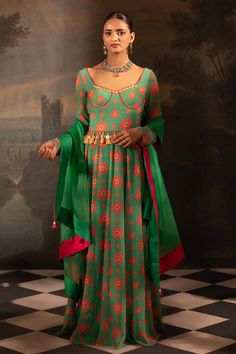 Green padded anarkali with botanical print and mirror, thread, pearl, bead, gota embroidered neckline. Paired with dupatta.
Components: 2
Pattern: Printed, Embroidery
Type Of Work: Floral, mirror, thread, pearl, bead, gota
Neckline: Notched
Sleeve Type: Churidar sleeves
Fabric: Georgette, Organza, Lining: Crepe
Color: Green
Other Details: 
Anarkali Length: 60 inches
Back tassel tie-up knot
Tassel bordered sheer dupatta
Occasion: Sangeet - Aza Fashions Mughal Theme Dress, Nikkah Dress, Saree Blouse Designs Latest, Theme Dress, Ghagra Choli, Dress Indian Style, Lehenga Designs, Indian Designer Outfits, Anarkali Dress