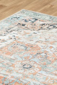 an orange and blue area rug on a wooden floor with wood floors in the background