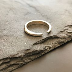 Discover the beauty of simplicity with our stunning Silver Minimalist Design Ring. Crafted with precision and elegance, this open-design ring embodies modern chic. Its versatile style allows you to wear it with the opening facing up or down, offering you two distinct looks in one piece. Made from high-quality sterling silver, this ring is not only a statement of understated luxury but also a versatile accessory that complements any outfit. Whether you're dressing up for an evening event or addin Minimalist Sterling Silver Midi Rings With Polished Finish, Modern Sterling Silver Open Midi Rings, Modern Sterling Silver Open Ring Midi Rings, Modern White Gold Open Midi Rings, Minimalist White Gold Open Band Jewelry, Silver Open Ring Stackable Rings In Minimalist Style, Minimalist Silver Stackable Rings With Open Band, Minimalist Silver Open Band Stackable Rings, Minimalist Adjustable Stackable Rings With Polished Finish