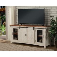 an entertainment center with a large flat screen tv on it's stand and shelves