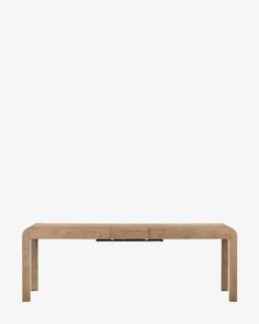 a wooden table sitting on top of a white wall