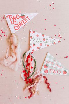 two sweet birthday party decorations on a pink background