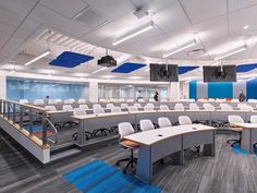 an empty office with desks and chairs