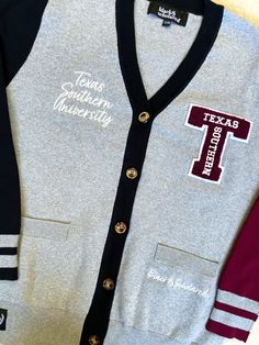 Make a bold statement and wear your Texas Southern pride with this one-of-a-kind and comfortable cardigan sweater, perfect for any alumni, students or supporters. Made with the highest quality materials, this sweater is designed to keep you warm and cozy while representing TSU! Features:- Official Texas Southern University logo embroidered on the chest- Large "T" Texas Southern Chenille patch- Classic cardigan design with a tortoise shell button-up front- Two front pockets (deep enough to fit a Collegiate Sweater With Ribbed Cuffs For Fall, Fall College Cardigan With Ribbed Cuffs, Collegiate Style Sweater For Game Day In Fall, Collegiate Fall Sweater For College, Fall College Sweater With Ribbed Cuffs, College Style Sweater For Fall Season, Ribbed Cuffs Sweater For College In Fall, College Style Cotton Sweater For Fall, Collegiate Sweater For Game Day In Winter