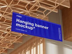 a blue sign hanging from the ceiling that says hanging banner mockup and free on it