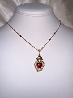 A beautiful 14k gold and red enamel sacred heart necklace on a 14k gold filled curb chain. Featuring cubic zirconia pave detailing on the pendant. Chain length: 17.5 Inch Red Heart Charm Fine Jewelry, Red Fine Jewelry With Heart Charm, Gold Heart Pendant Necklace With Jewels, Gold Plated Heart Beads Pendant Jewelry, Red Heart Pendant Necklace In 14k Gold, Gold Plated Heart Pendant Jewelry, 14k Gold Filled Pendant For Valentine's Day, 14k Gold Filled Pendant Jewelry For Valentine's Day, Red 14k Gold Heart Pendant Necklace