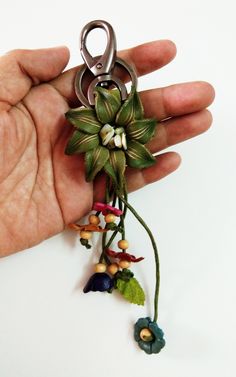 "Genuine Leather Flower Keychain Bag Charm, Inspired Small Dahlia Green Floral Hook Real Purse Charm, Handbag Zipper Charm Accessories  Material : Genuine Leather Color : As Picture Size Approx : Diameter of flowers 2\" : Total about 5.5\" in length including the hanging string (The Hanging String Is About 2\" ) Quantity : 1 Pc. Thai handmade Beautiful design for Bag/Purse Charm Keychain Charm Bag Purse Flower Floral Hook Handmade Bag Wallet Gift Accessories Lady String Decoration Unique Gift Cute Beautiful  Please note: - Picture may did not show the actual size because it was enlarged to show product detail, please refer to the item description for accurate product size. - The color display on your monitor may slightly differ from the actual product according to color setting of differen Charm Accessories, Flower Keychain, Leather Flower, Keychain Charm, Keychain Bag, Zipper Charms, Charm Keychain, Wallet Gifts, Leather Flowers